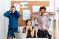 Colleagues closing mouth, eyes and ears with hands in office. See-hear-speak no evil variation. Royalty Free Stock Photo