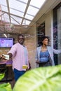 Colleagues collaborating in office at glass partition with annotations using tablet Royalty Free Stock Photo