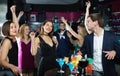 Colleagues dancing on corporate party with cocktails in hands