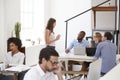 Colleagues in discussion around a desk in open plan office Royalty Free Stock Photo