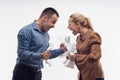 Colleagues fighting each other with paper in fists
