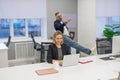Colleagues fooling around at work in the office. Royalty Free Stock Photo