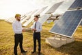 Colleagues in formal wear discussing solar power station project Royalty Free Stock Photo