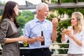 Colleagues having sausages and beer after work