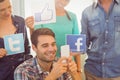 Colleagues holding sign from famous social networks