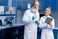 Colleagues in lab coats using digital tablet during work Royalty Free Stock Photo