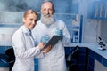 Colleagues in lab coats using digital tablet during work Royalty Free Stock Photo