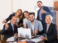 Colleagues looking at laptop and smiling