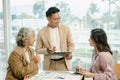 Colleagues at meeting in boardroom, sitting at table together, sharing ideas, discussing project strategy. Royalty Free Stock Photo