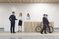 Colleagues in office with wooden reception Royalty Free Stock Photo