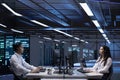Colleagues in server farm overseeing equipment systems