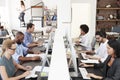 Colleagues sit using computers in a busy open plan office Royalty Free Stock Photo