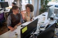 Colleagues talking, smiling, watching each other at work  in modern open space office. casual modern business Royalty Free Stock Photo