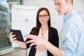 Colleagues Using Digital Tablet In Office Royalty Free Stock Photo