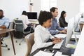 Colleagues work at computers in open plan office, side view Royalty Free Stock Photo