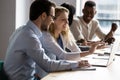 Colleagues working on common project prepare presentation using laptop Royalty Free Stock Photo