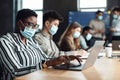 Colleagues working on a project in office, using pc Royalty Free Stock Photo