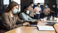 Colleagues working on a project wearing face masks using technology Royalty Free Stock Photo
