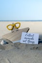 COLLECT MOMENTS NOT THINGS text on paper greeting card on background of funny starfish in glasses summer vacation decor Royalty Free Stock Photo