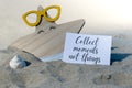 COLLECT MOMENTS NOT THINGS text on paper greeting card on background of funny starfish in glasses summer vacation decor