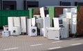 Old electrical appliances, washing machines in container. Consumerism problem