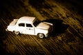 Collectible toy model of an old car with a taxi symbol on a wooden background. Selective focus. Copy space Royalty Free Stock Photo