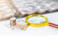 Collecting coins numismatics album with magnifying glass Royalty Free Stock Photo