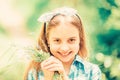 Collecting flowers in field. Kid hold flowers bouquet. Girl cute adorable teen dressed country rustic style checkered Royalty Free Stock Photo