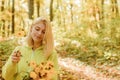 Collecting forest flowers. Blonde enjoy relax forest. Autumn bouquet. Warm autumn. Girl with flowers. Woman walk autumn