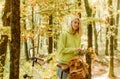 Collecting forest flowers. Blonde enjoy relax forest. Autumn bouquet. Warm autumn. Girl with bicycle and flowers. Woman