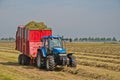 Collecting grass with tractor and silage wagon Royalty Free Stock Photo