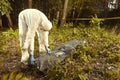 Observing and pick up of human skeleton by criminologist technician