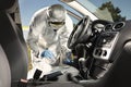Collecting of odor traces by criminologist from car Royalty Free Stock Photo