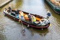 Collecting waste from canal, Leiden, Netherlands