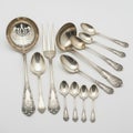 A collection of antique silverware utensils and dishware on display Royalty Free Stock Photo