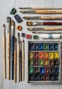 A collection of art tools arranged on a wooden surface. Various sizes of paintbrushe Royalty Free Stock Photo
