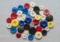 A collection of assorted buttons on a gray fabric background Royalty Free Stock Photo