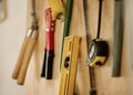 A collection of assorted tools and equipment on a wall. Tools and equipment on a wall. Maintenance tools hanging on