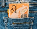 A collection of Australian banknotes.dollars in a jeans pocket, closeup.A few bills of one hundred dollars stick out . Royalty Free Stock Photo