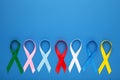Collection of awareness ribbons on blue. World cancer day