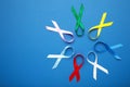Collection of awareness ribbons on blue. World cancer day