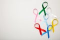 Collection of awareness ribbons on grey with copy space. World cancer day