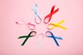 Collection of awareness ribbons on pink. World cancer day