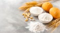 A collection of baking essentials is displayed on a kitchen countertop, featuring eggs, wheat stalks, flour in bowls Royalty Free Stock Photo