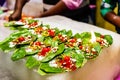 Collection of banarasi paan betel leaf with masala displayed with displayed for sale at a shop.