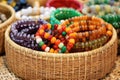 collection of beaded bracelets in a bamboo basket