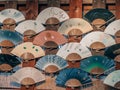 Collection of beautiful Japanese fans hung on a wall