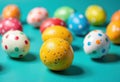 Colorful Easter eggs with polka dots on a vibrant turquoise background Royalty Free Stock Photo