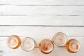 Collection of beer mugs on white wooden table with copyspace.