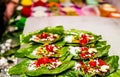 Collection of betel leaf banarasi paan and fire paan displayed for sale at a shop with selective focus and blurred